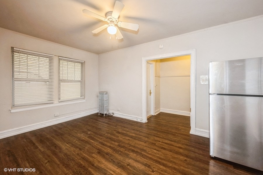 studio apartment living area and kitchen with stainless steel appliances at ivy at sylvan hyde park apartments near uchicago